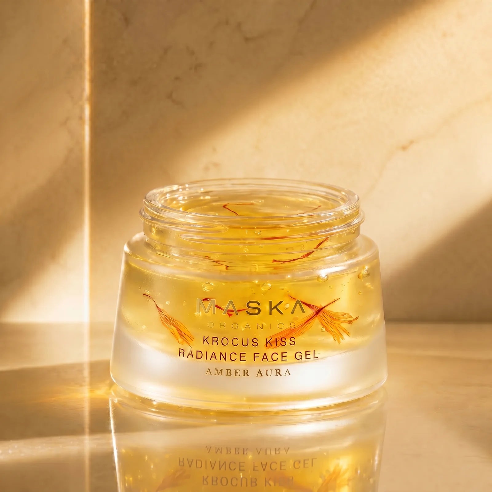 Krocus Kiss Radiance Face Gel displayed with saffron strands, highlighting the Ayurvedic-inspired botanical formulation